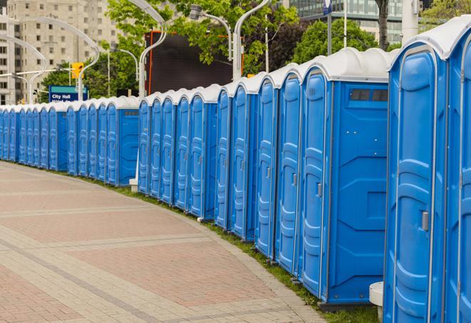 a row of portable restrooms at a fairground, offering visitors a clean and hassle-free experience in fortdefiance